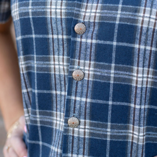 Close-up of a blue plaid shirt with buttons