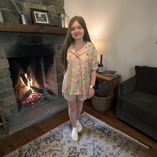 Two Heifers Mama two piece pajama set in light yellow with colorful polka dots and pink trim. Short sleeves and shorts.
